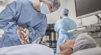 woman healthcare worker holding a patient's hand in the hospital room