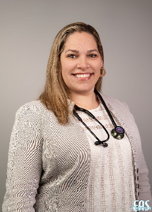 Brandi Galloway headshot wearing a sweater set and stethoscope