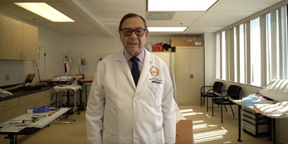 Carlos Torres standing in a hospital room
