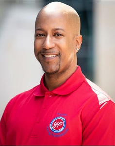 DaMarcus Sullivan headshot in a red polo