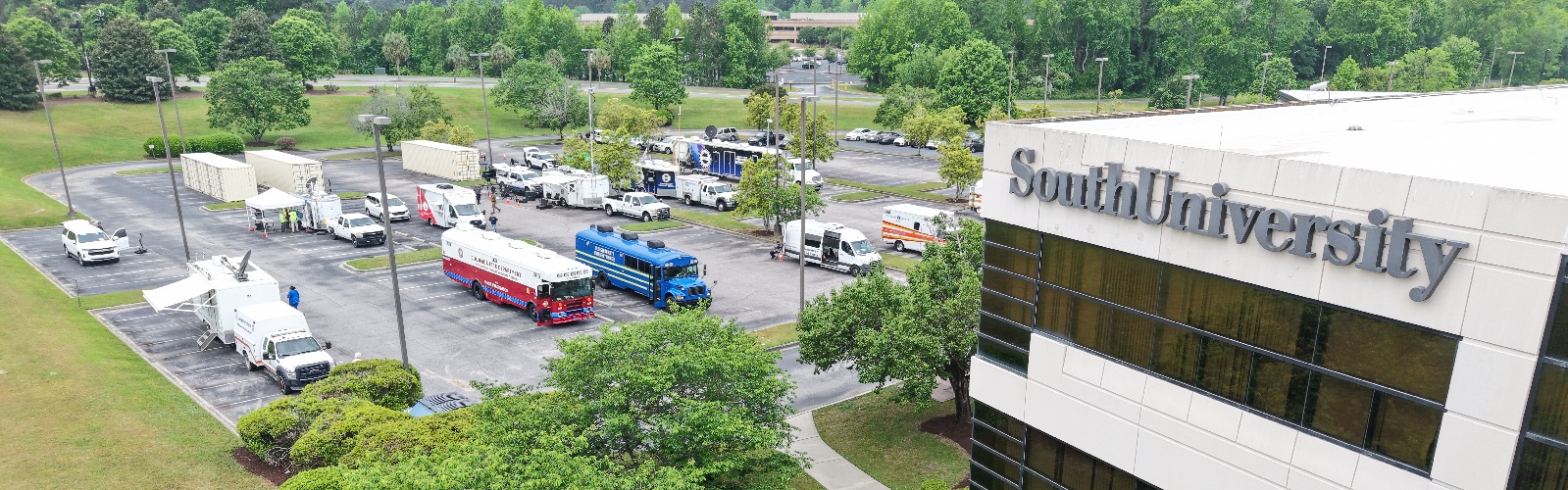 South University campus building with disaster relief vehicles in the parking lot