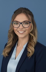 Joanna Wolf headshot in a South University Stingray sweatshirt