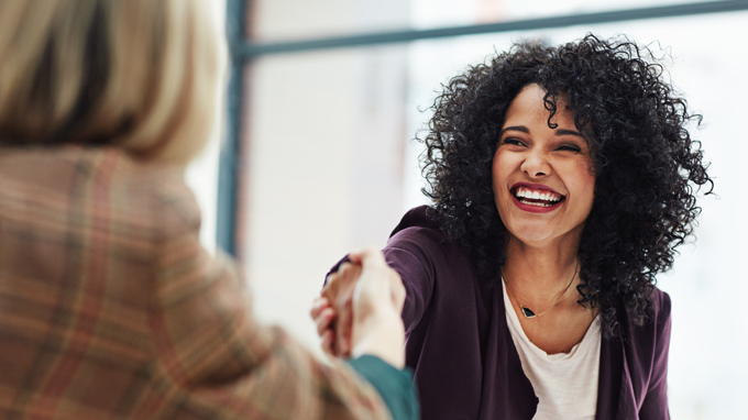 Female leader laughing with coworker