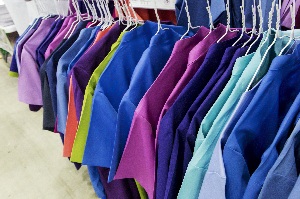 modern colorful scrubs hanging in a row in a closet