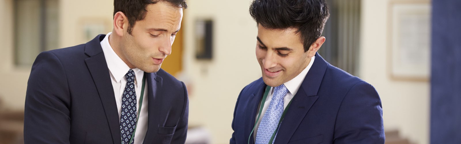 Two business professionals reviewing information on tablet