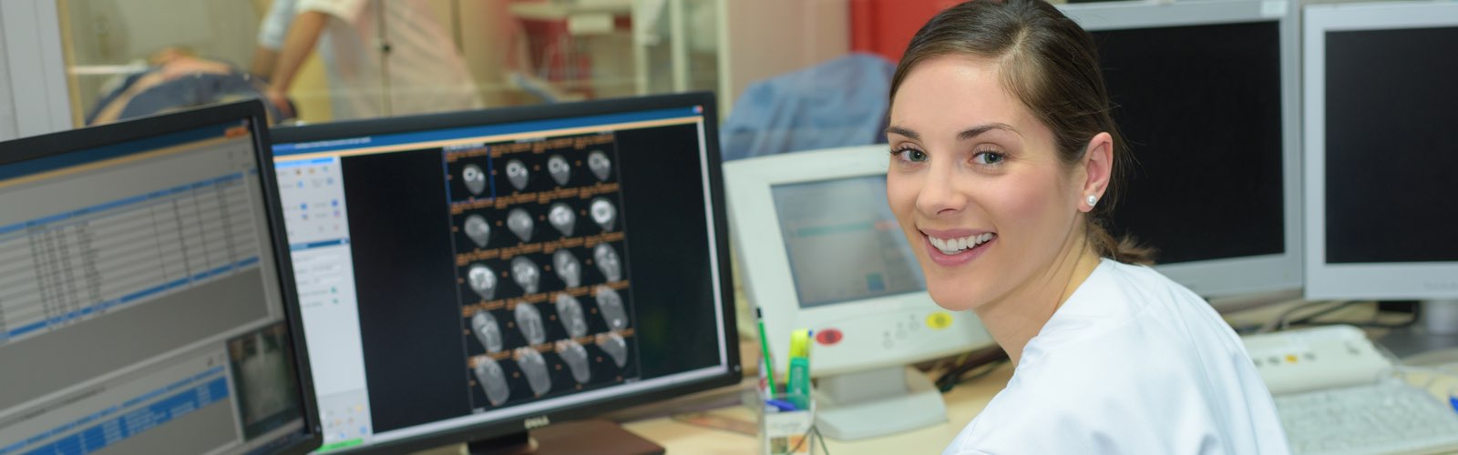 Female healthcare administrator sitting at desk smiling