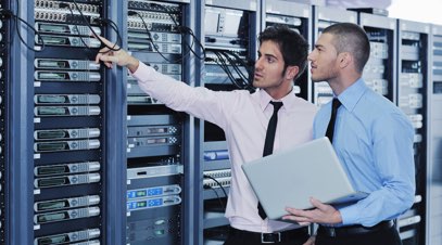 Information technology professionals inspecting server racks-alt-text