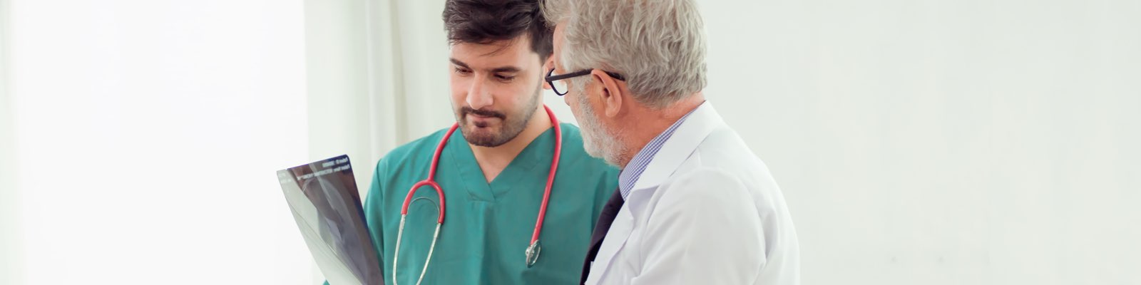 Medical practicioner discussing x-ray with doctor