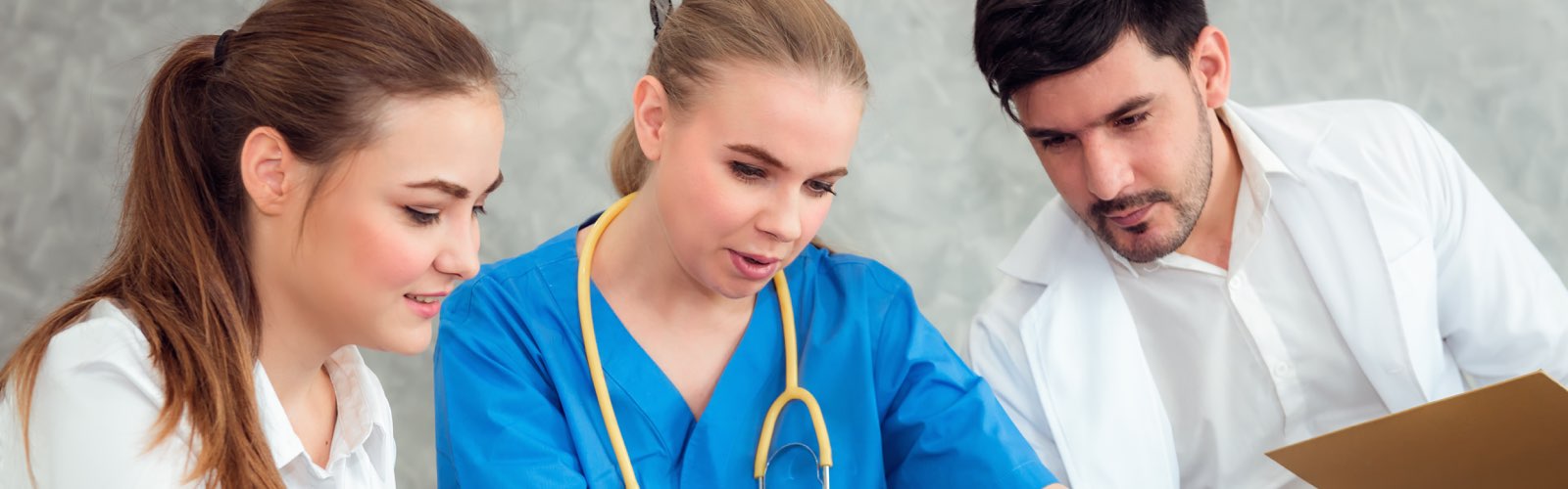 Nurses and doctor looking at laptop