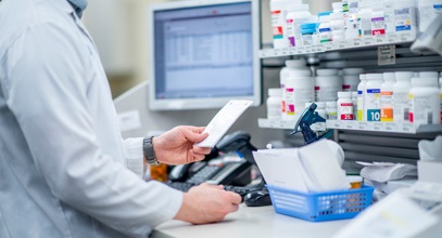 pharmacist prepping prescriptions at a pharmacy