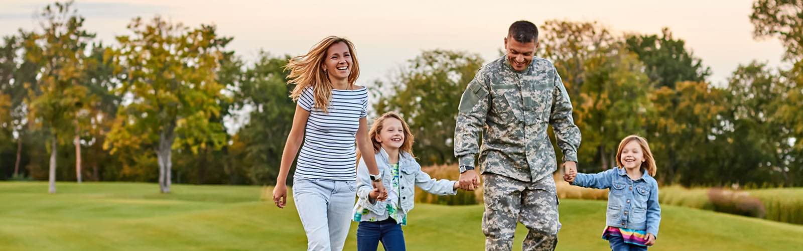 Military serviceman with family in park